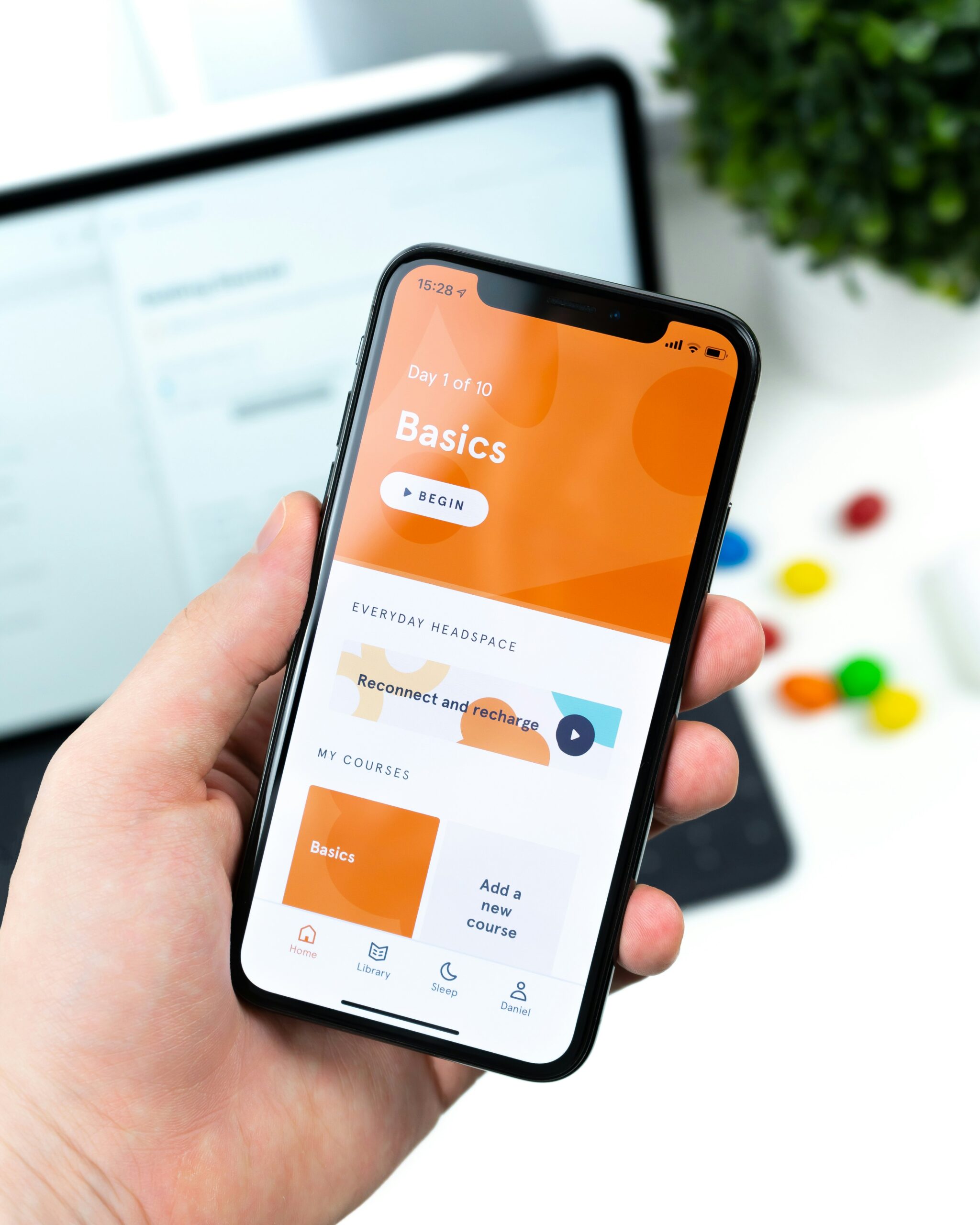 Hand holding phone with mobile app interface. best bank accounts for young adults