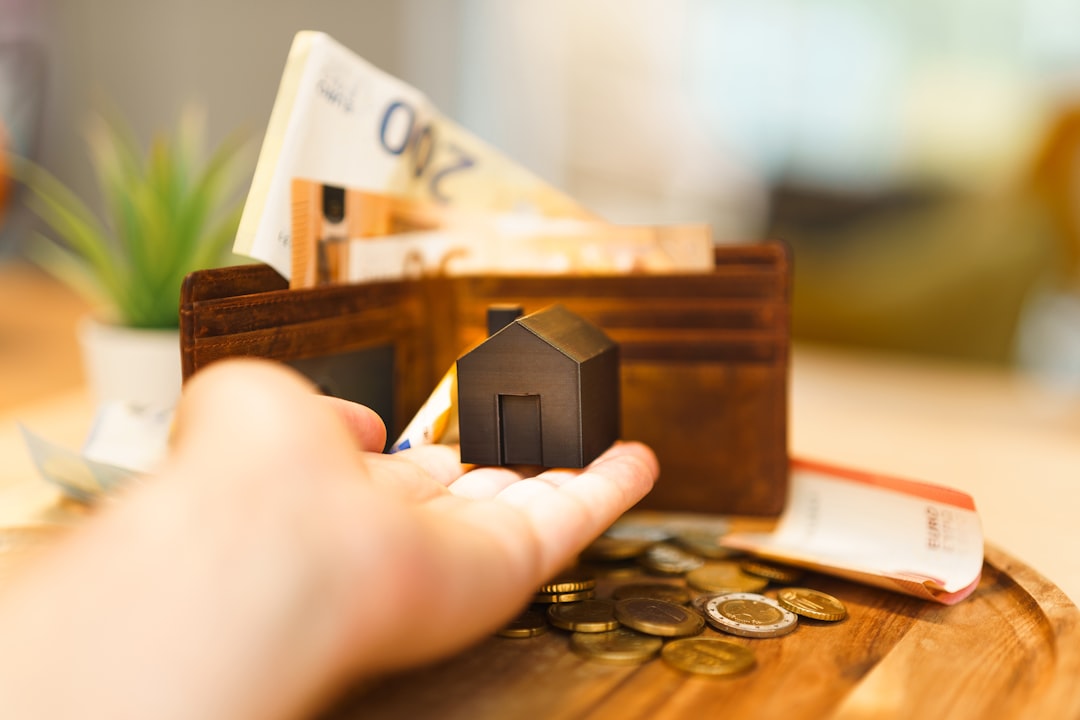 Young couple reviewing financial documents and calculator while planning house deposit savings