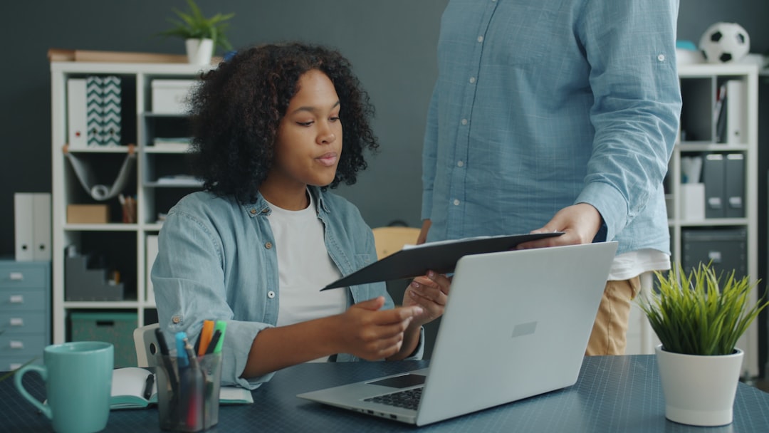 Parent reviewing tax documents with calculator for Child Tax Credit reconciliation
