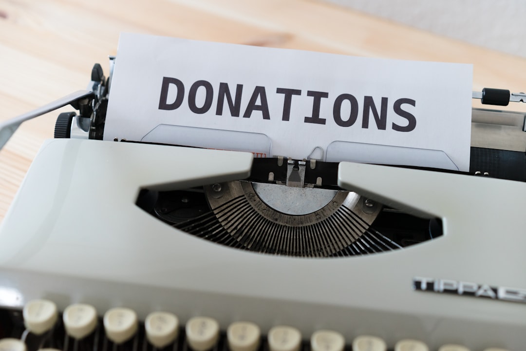 Gift Aid declaration form with pen and calculator showing tax relief on charity donations