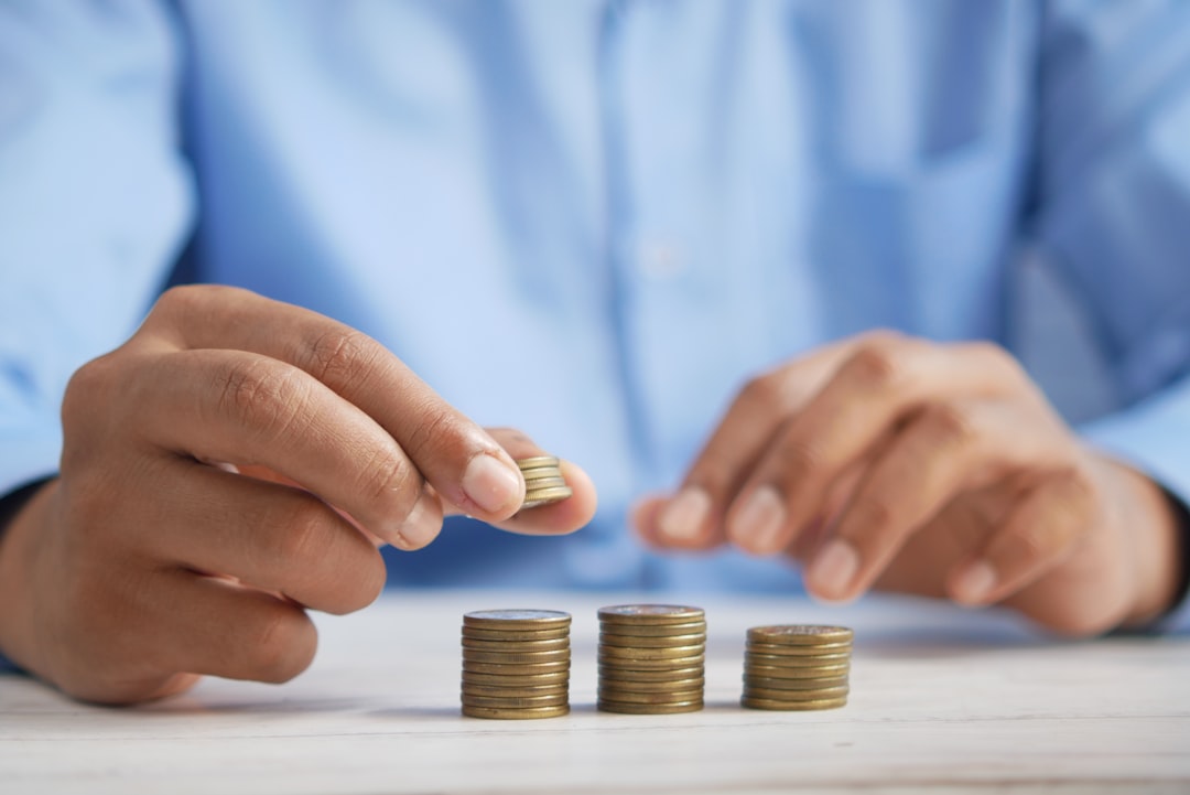 Young adult reviewing budget charts and savings jar to build wealth in their 20s