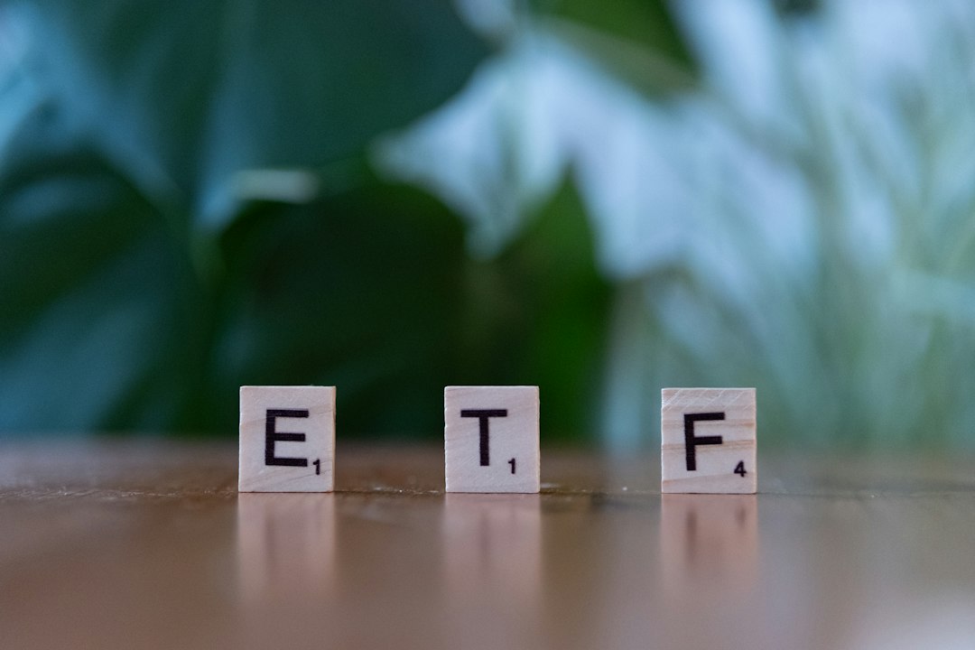 Stacked coins and rising bar chart symbolizing ETF versus mutual fund investing