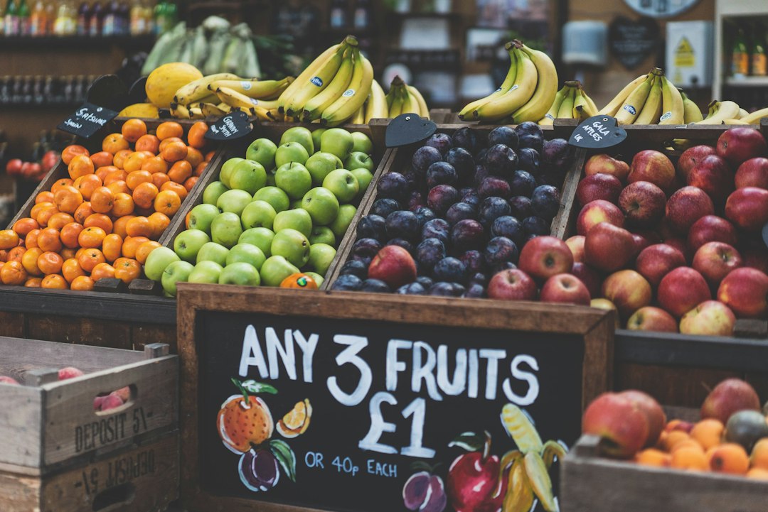 Shopping basket filled with groceries and UK coins symbolizing food budget savings