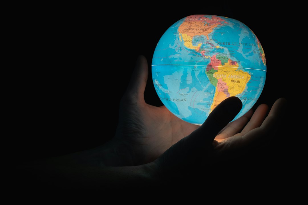 Globe surrounded by stock market charts and coins symbolizing global index fund investing